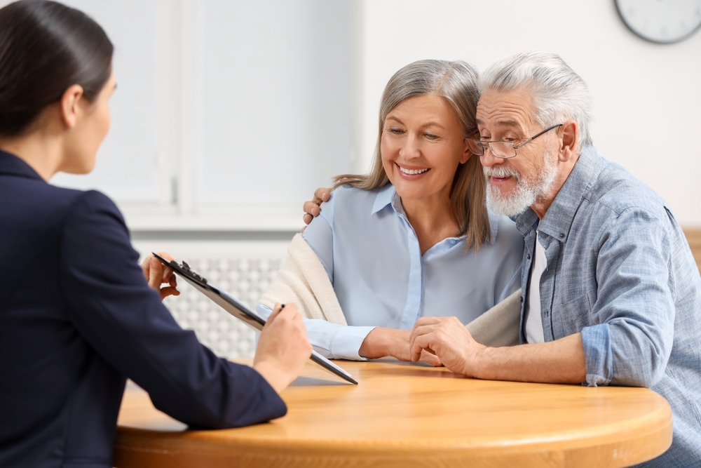 Old couple discussing with advisor